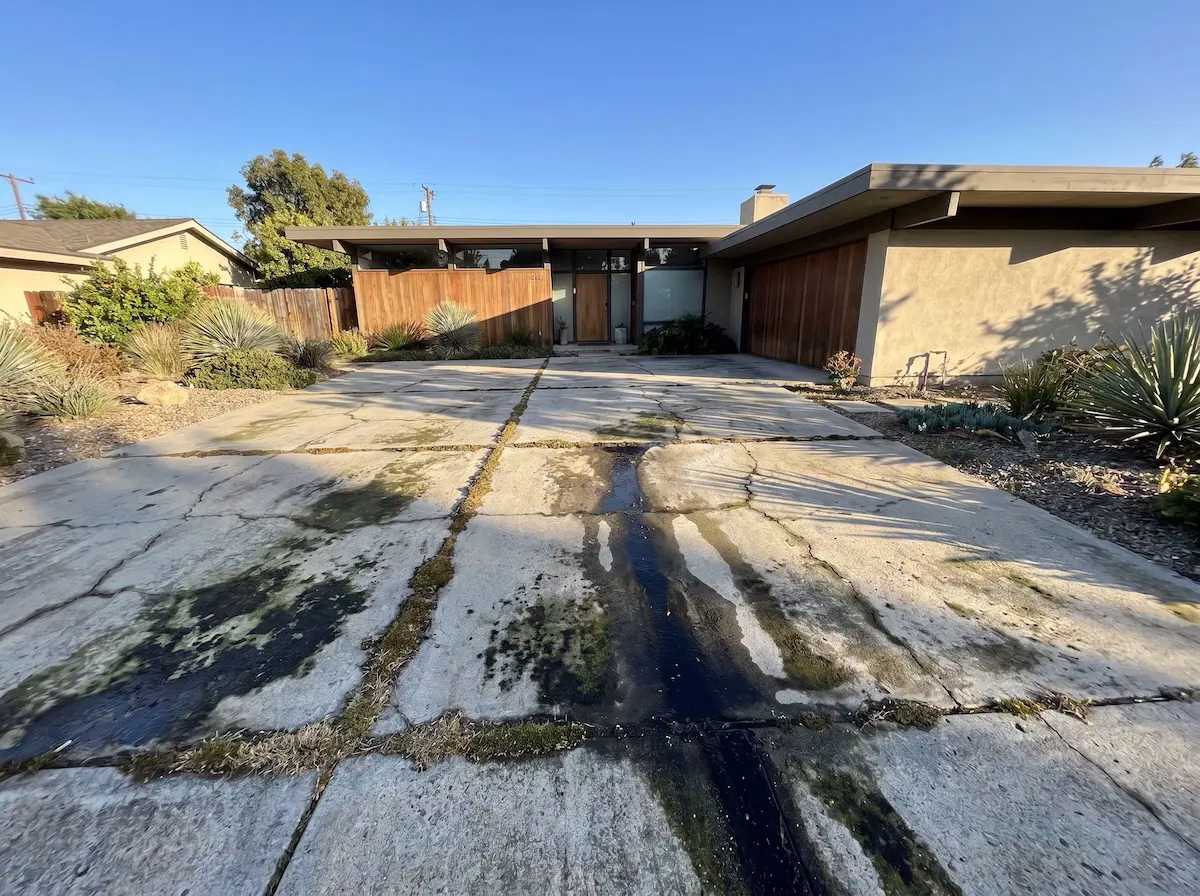 Dirty stained concrete driveway before pressure washing — Napa Valley